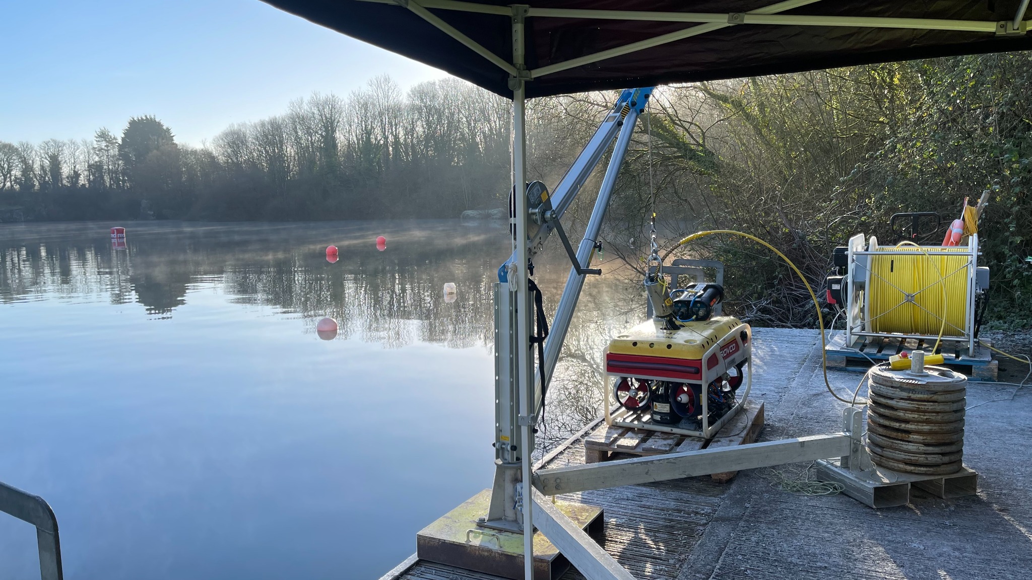 Inspection ROV and launch equipment beside a reservoir